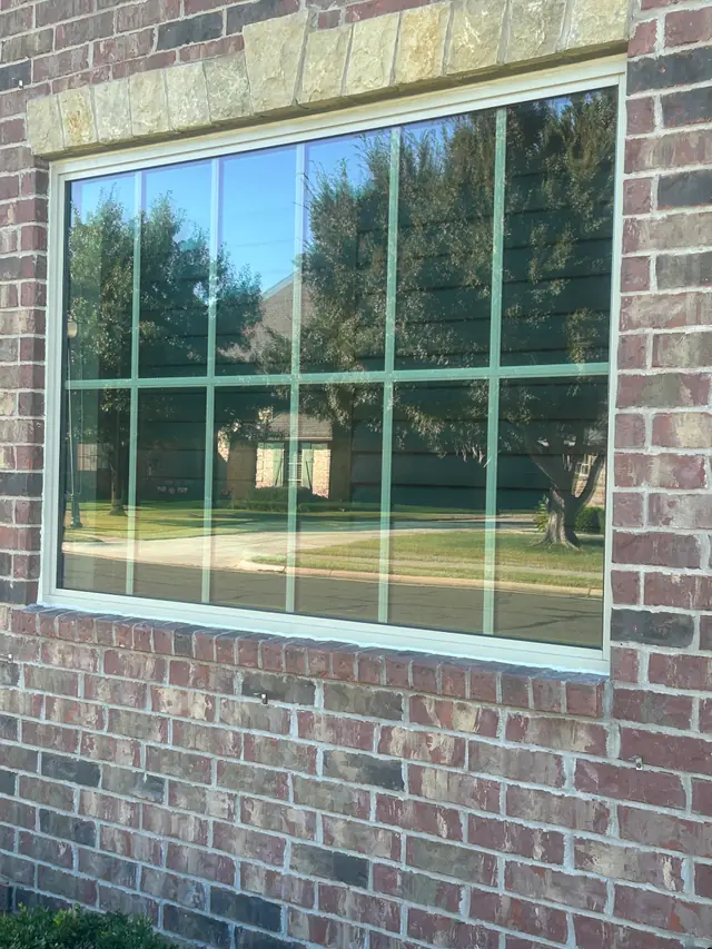 New window set in a brick wall under a stone lintel